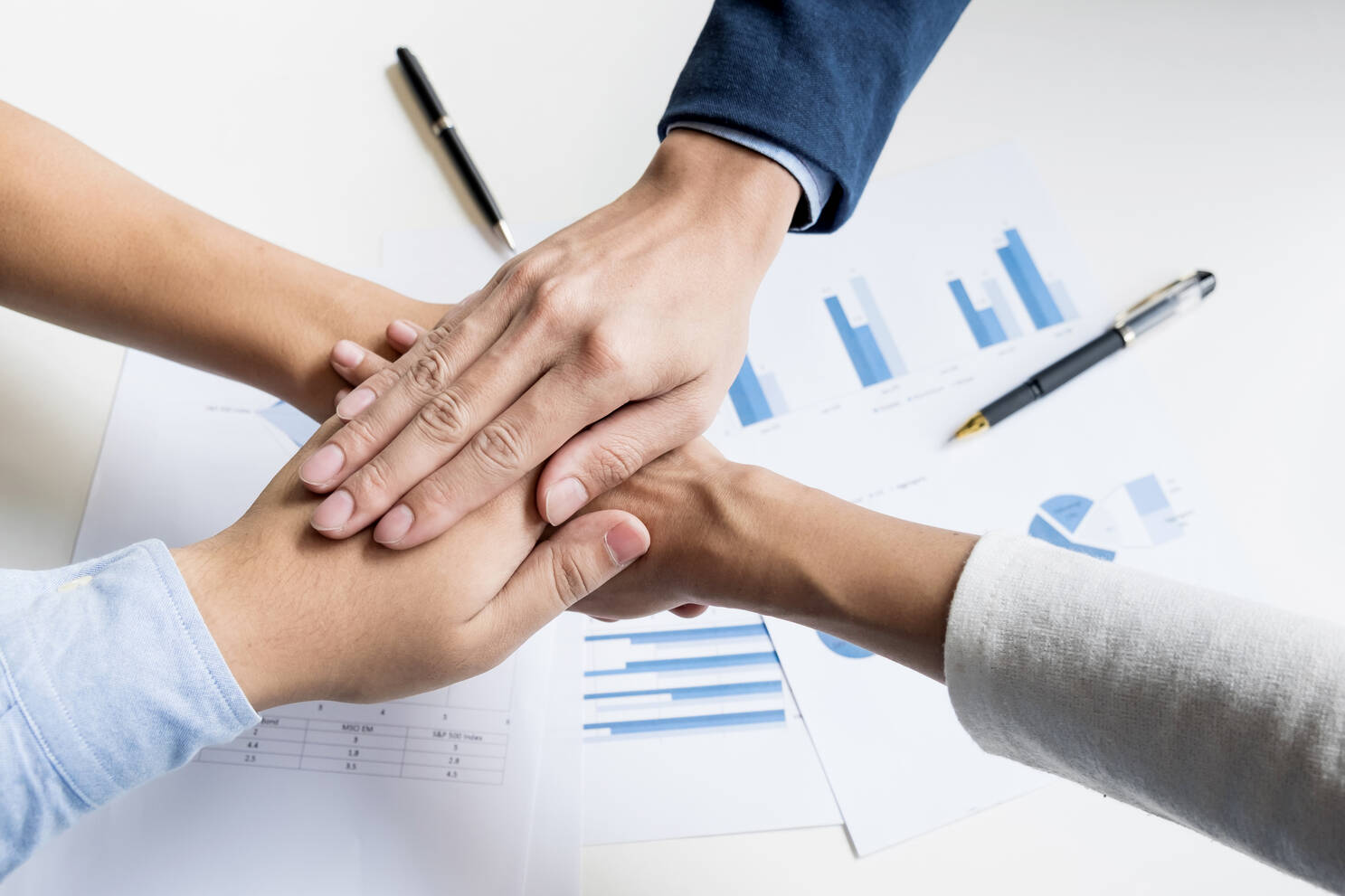 Team of professionals collaborating during a business meeting in a modern workplace, symbolizing teamwork and success